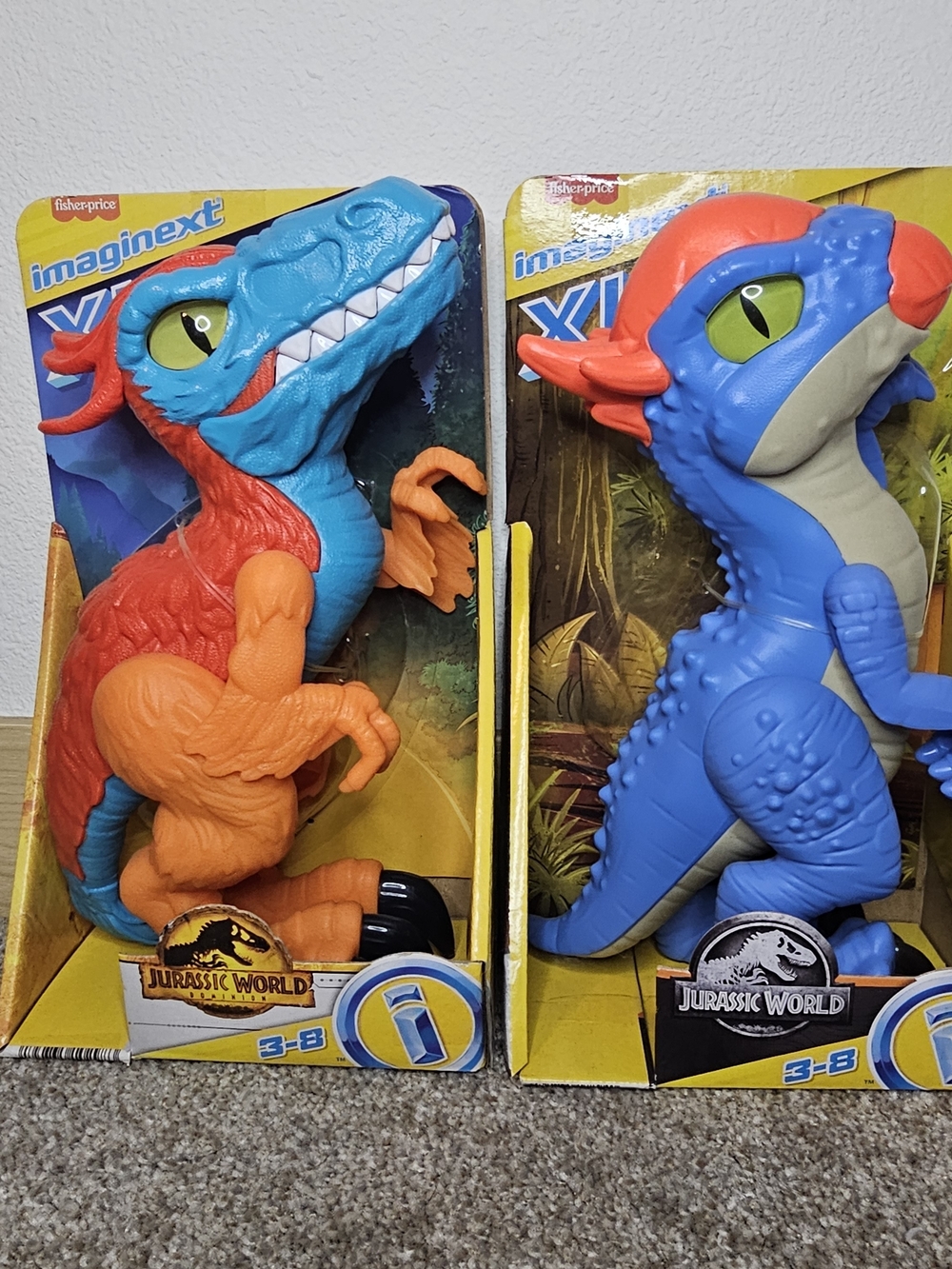 Fisher-Price Imaginext Dual-Color Raptor Figures in Blue and Orange